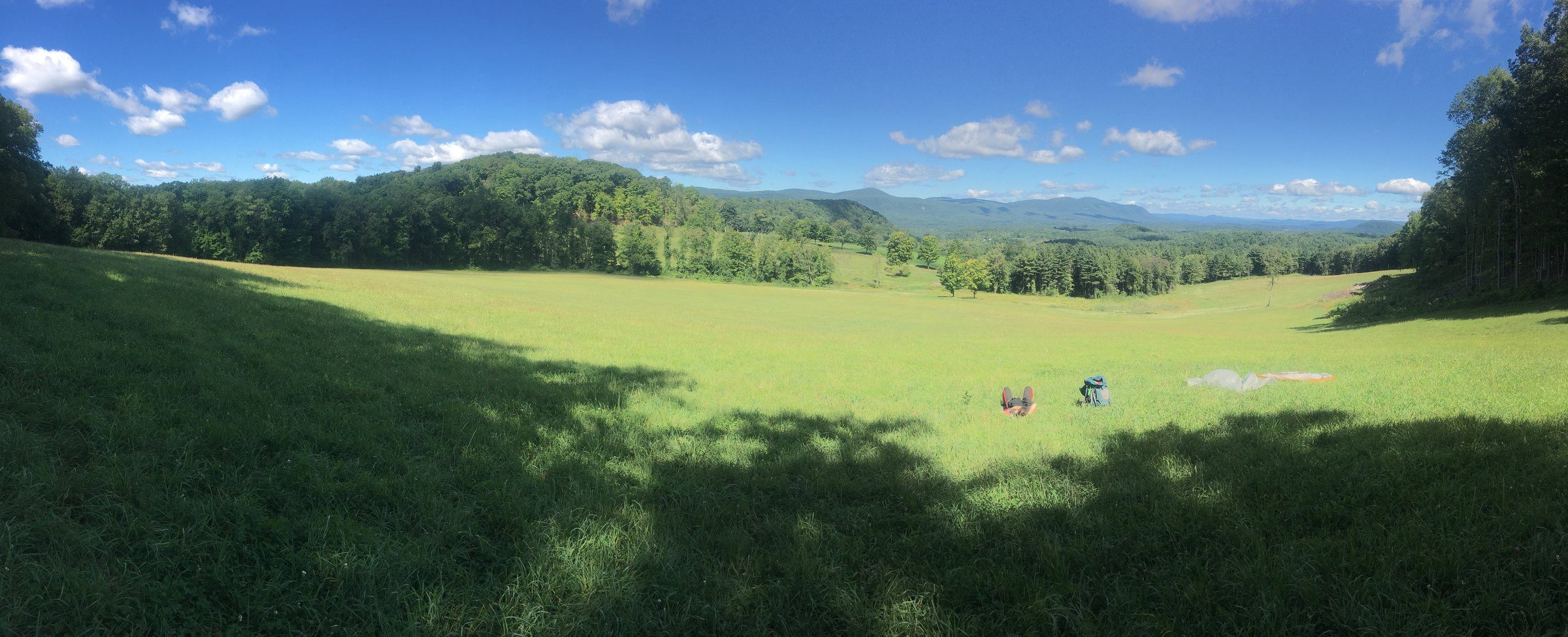 Mountain view beside a wooden mileage marker