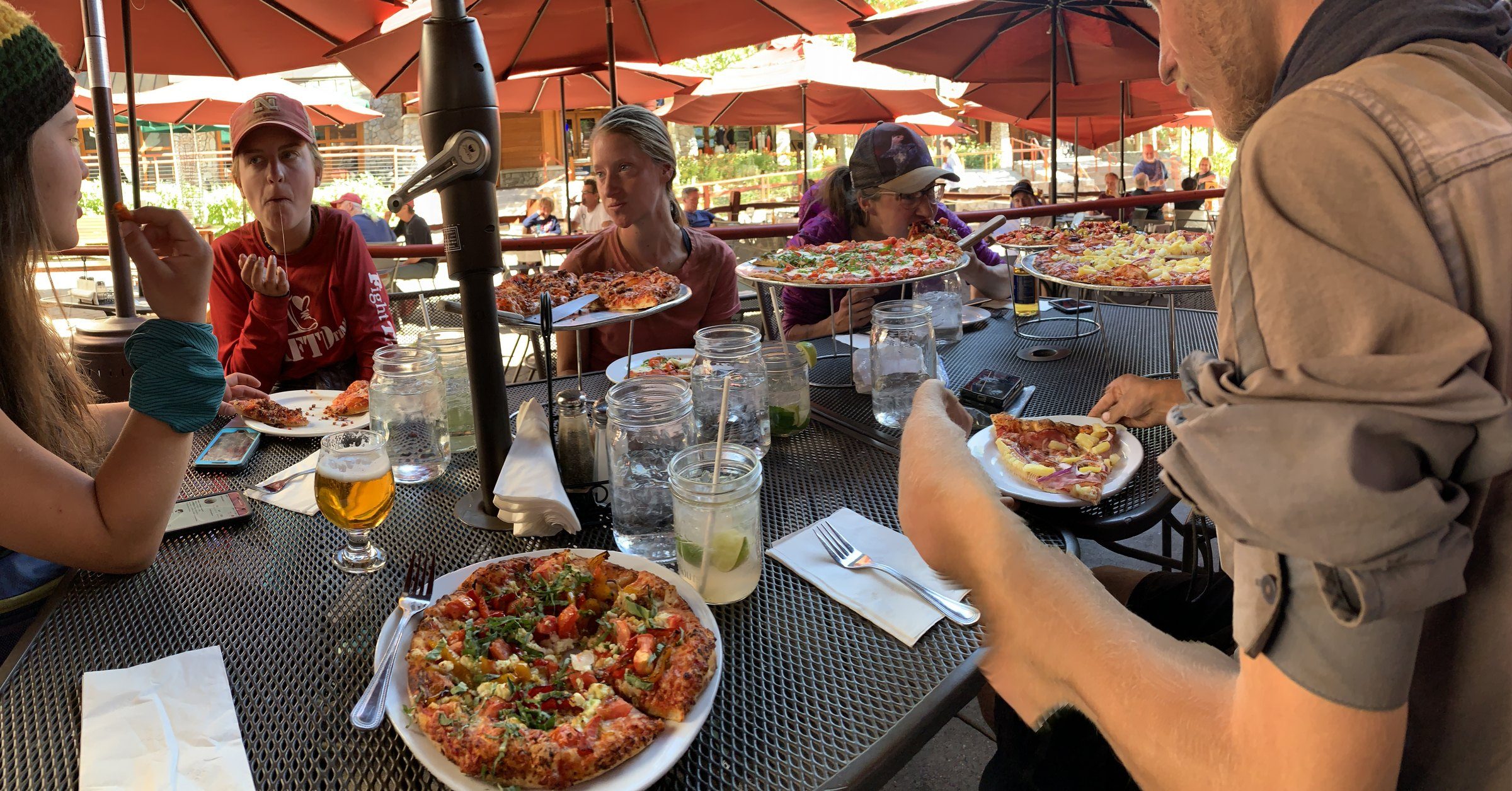 Hikers gathered around a table with food