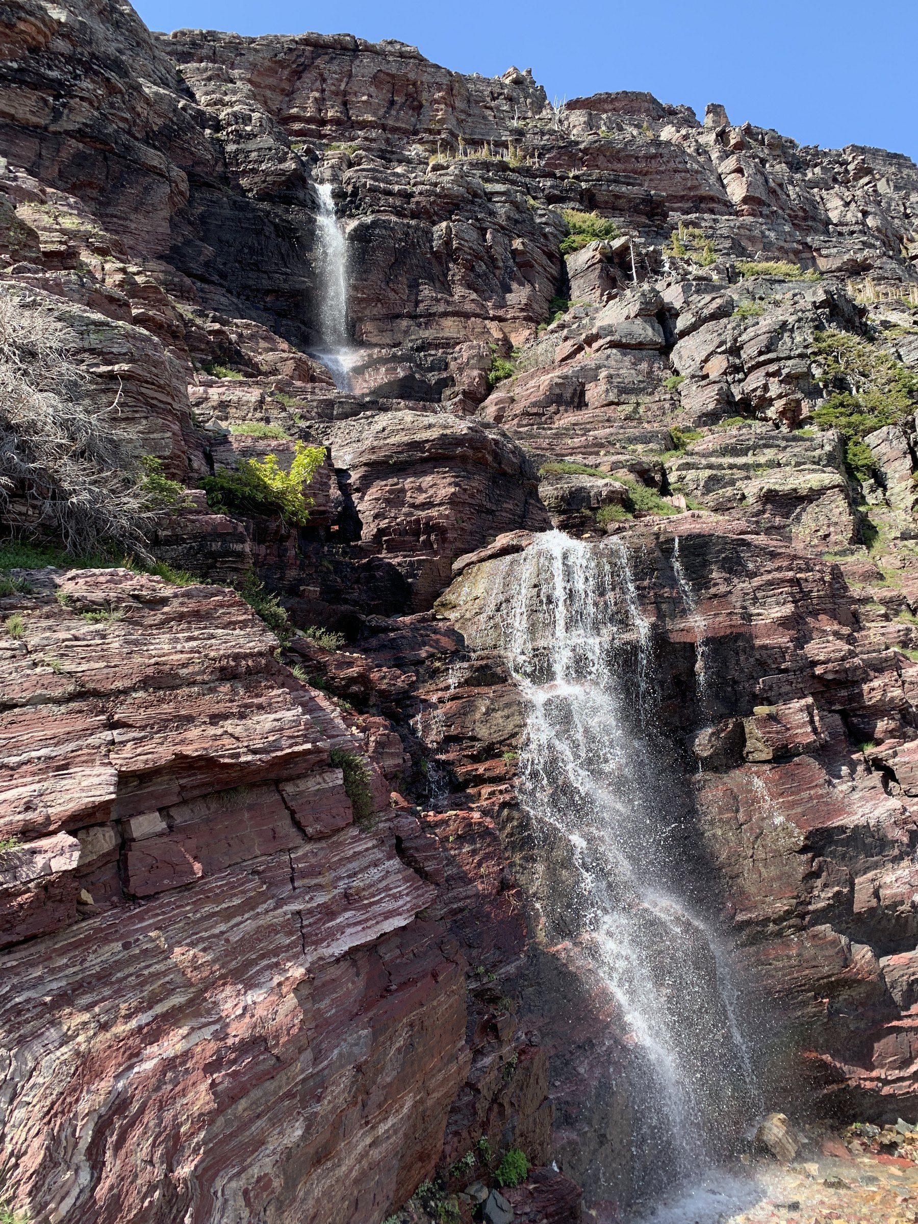 Red rocky peaks and a waterfall