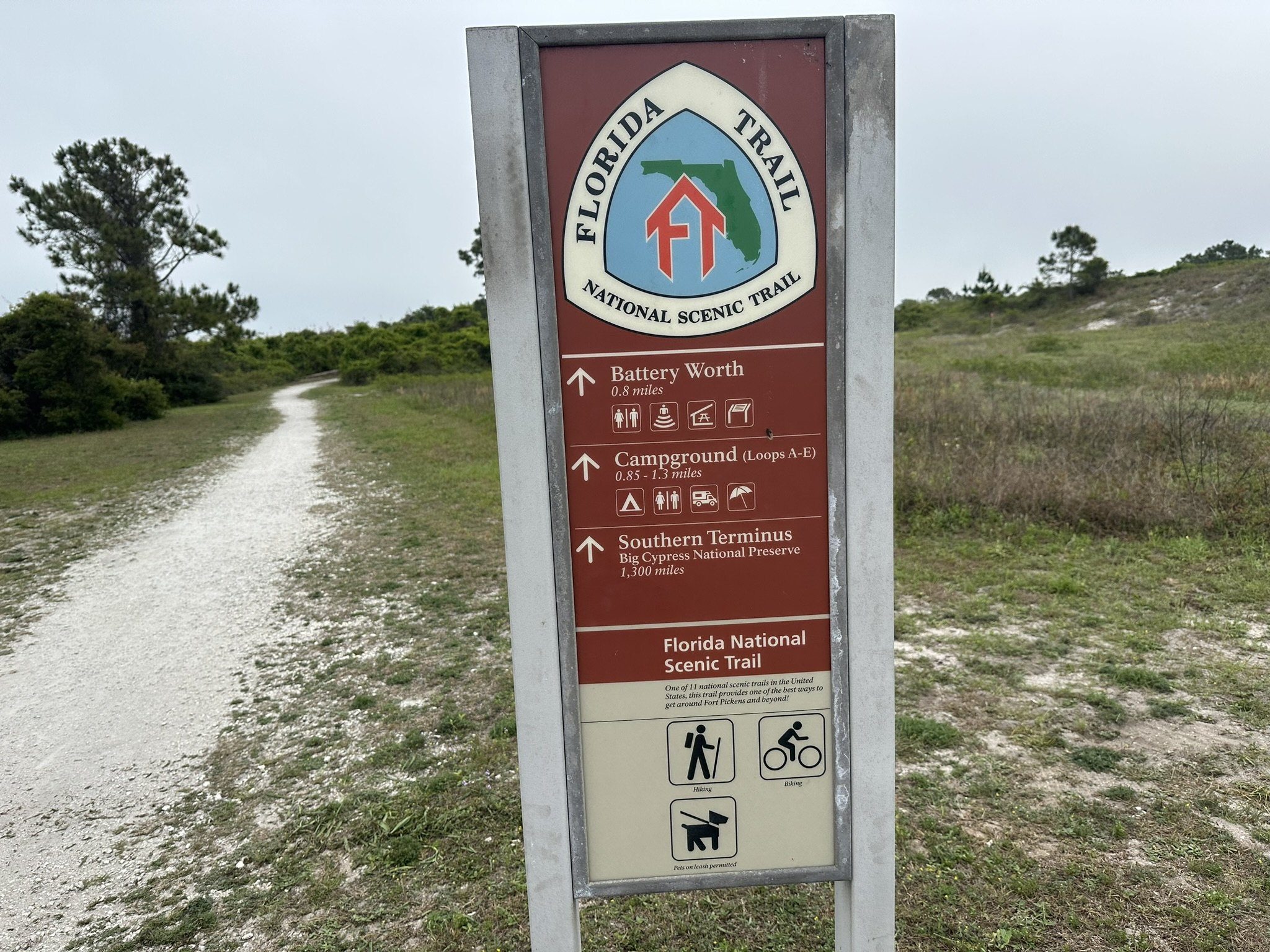 Trail terminus sign beside a path