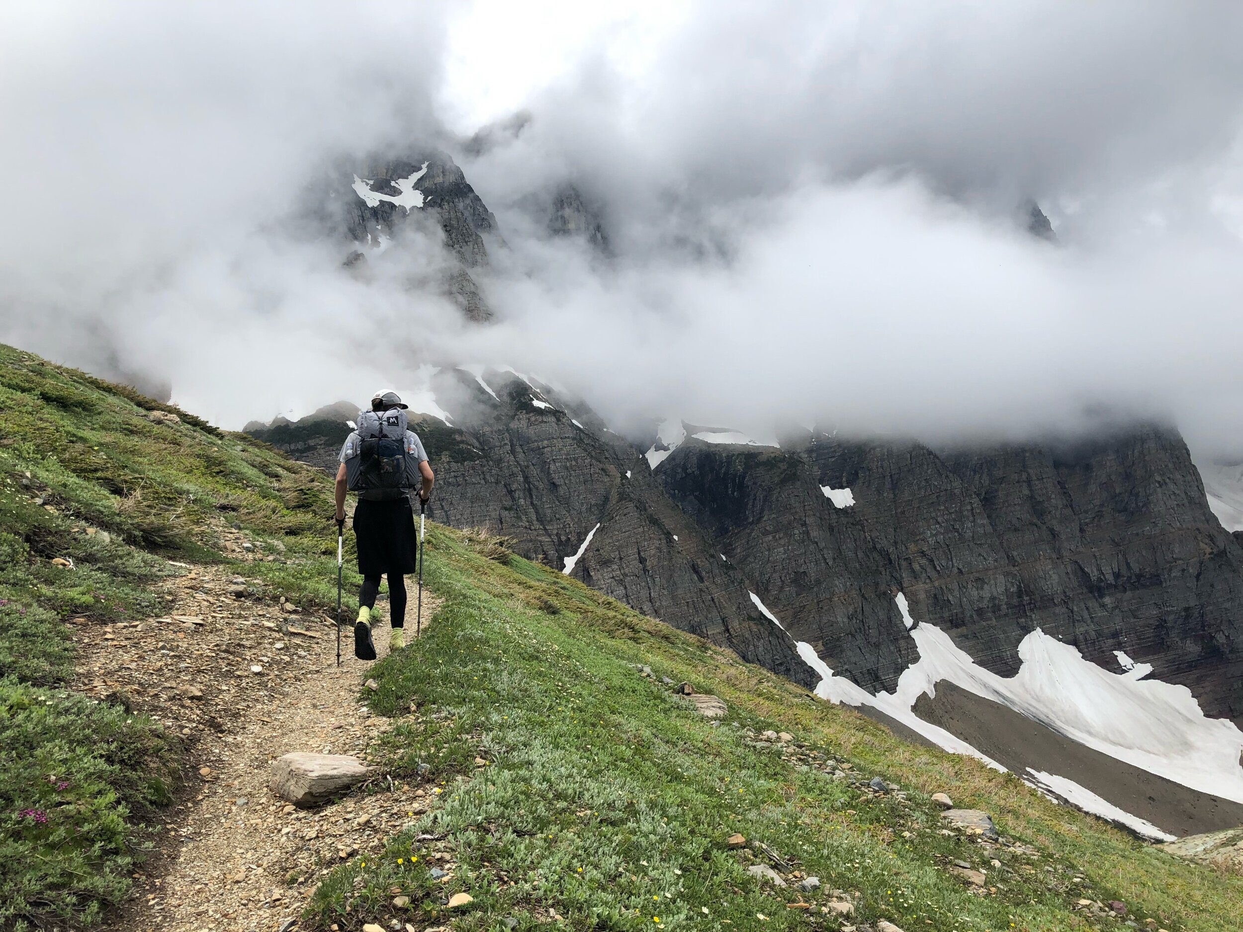 Jeremy hiking toward cloud-wrapped peaks on the Continental Divide Trail